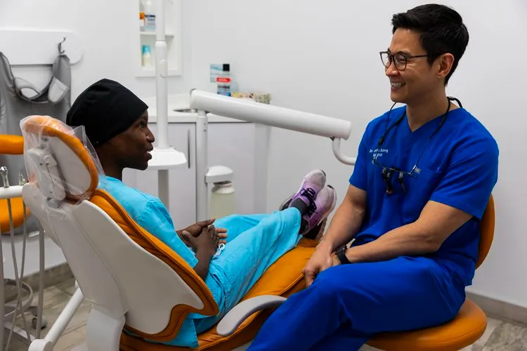 dentist performing dental exam dentist performing dental exam